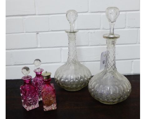 A pair of Globe and Shaft decanter and stoppers, together with a group of three condiment bottles, (5) 