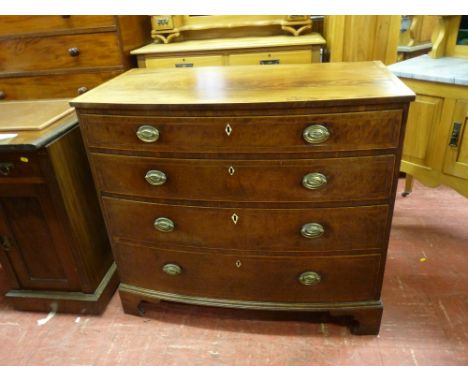 A REGENCY INLAID MAHOGANY BOW FRONT CHEST of four long drawers with oval backplates and swing handles, ivory escutcheons, box