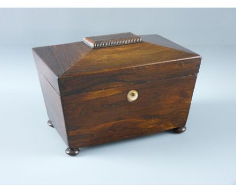 A VICTORIAN ROSEWOOD TEA CADDY of sarcophagus form on turned bun feet, the interior with twin lidded compartments, 13.5 cms h
