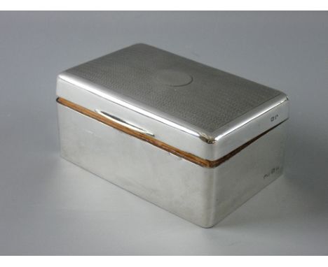 A HALLMARKED SILVER CIGARETTE BOX, the lidded top with engine turned decoration, Birmingham hallmarks semi-rubbed, probably 1