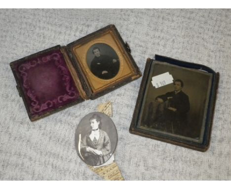 Two cased ambrotype photographs and a Victorian photograph on enamel oval plaque