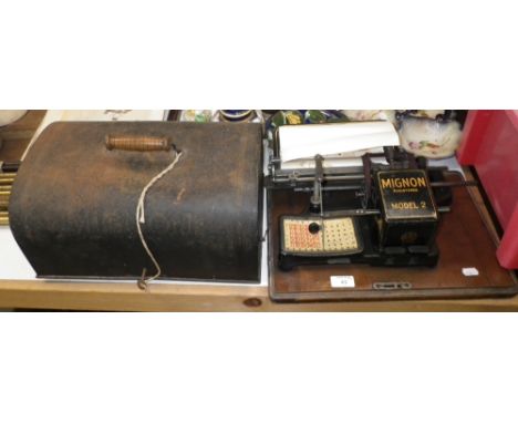 An early 20th century Mignon typewriter (Model II) on a mahogany base with a japanned tin cover