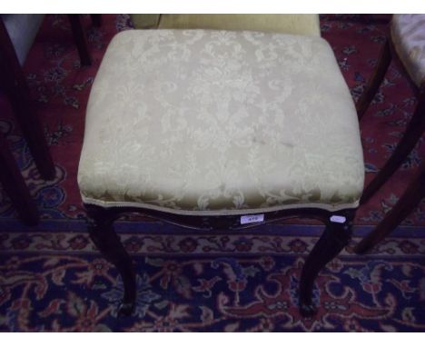 An Edwardian stool with cabriole legs