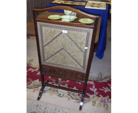An Edwardian fire screen with needlework panel