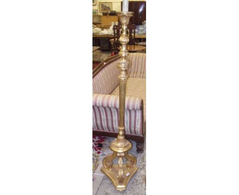A giltwood standard lamp with all over carved decoration