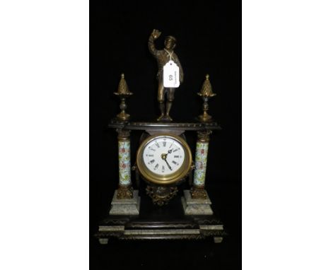 A Regency style mantel clock with enamel columns, decorated with a brass figure