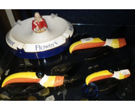 Three Carltonware flying Toucan Guinness ornaments and a Flowers ashtray
