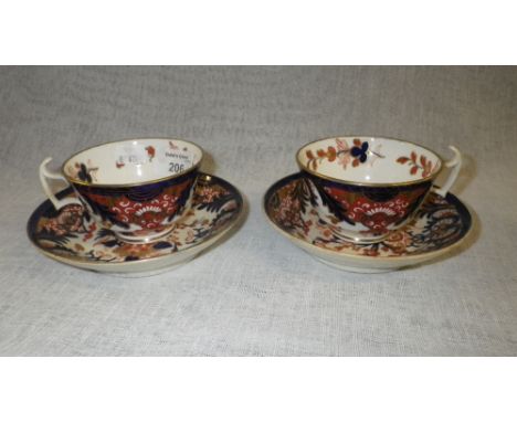 A pair of Derby cups and saucers with floral and foliate decoration