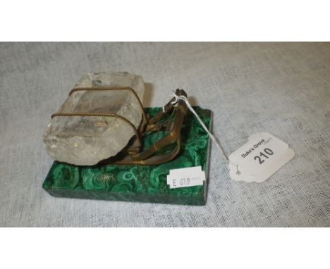 A rock crystal 'ice' block on a miniature gilt sled on a malachite base