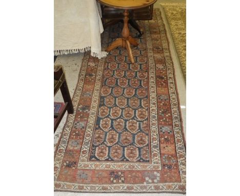 A blue ground runner with red borders, c. 40" x 160"