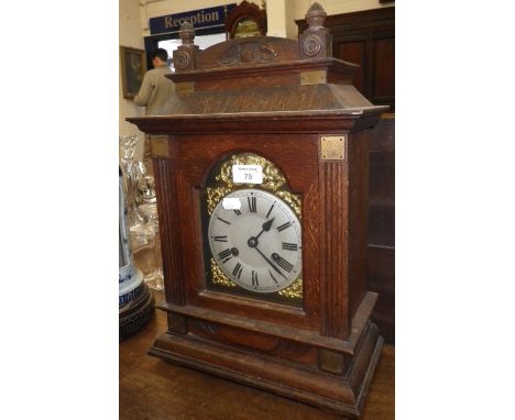 An Edwardian oak-cased mantel clock with silvered dial