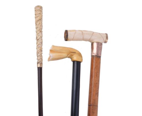 Ω Three ivory handled walking sticks, comprising: a 19th century Chinese cane, the tapering handle carved with a dragon amids