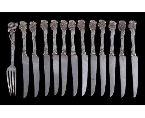  A set of twelve Art Nouveau silver fruit knives and one fork,   unmarked, the knife blades with indistinct signatures, circa