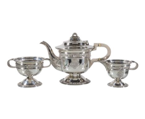 Ω An Irish silver circular pedestal three piece tea service by Alwright &amp; Marshall Ltd, Dublin 1944, the tea pot with a l