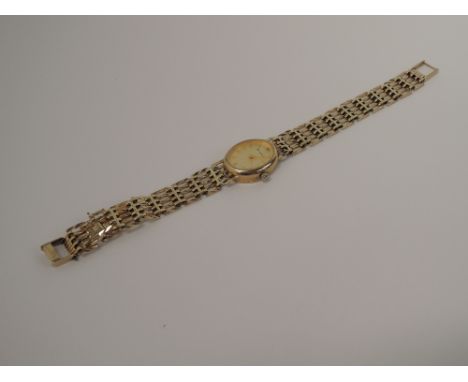 A ladies 9ct gold Accurist quartz wrist watch having a gate style bracelet