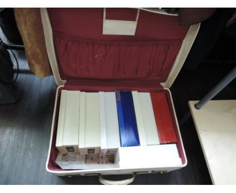 A vintage suitcase by Antler containing 7 pairs of vintage ladies shoes