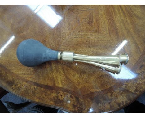 A vintage brass triple car horn