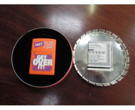 A Zippo Millennium series lighter, in case, Get Over It!