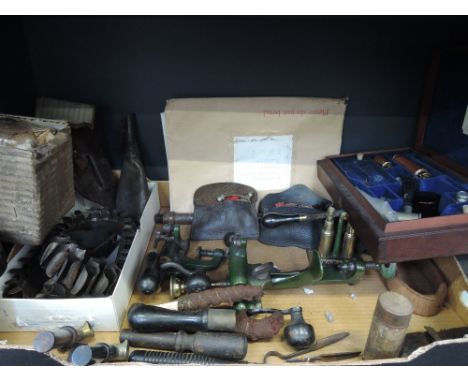 A box containing 19th century and later cartridge making equipment and gun cleaning tools, including James Dixon & Sons Sheff