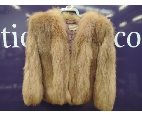 A ladies vintage caramel coloured short fur cape, retailed in Carlisle
