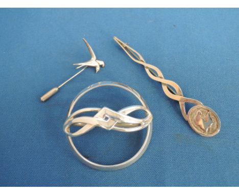 An Scottish HM silver Scarf brooch of Celtic design by Ola Gorie, a silver stick pin having bird decoration and a silver kilt