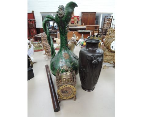 A stoneware ewer having green enamel glaze and Art Nouveau decoration, a Spelter urn having Art Nouveau decoration, Smiths re