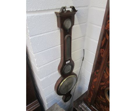 An early 19th century mahogany cased wheel barometer having swan neck pediment with thermometer scale and silvered dial by D 