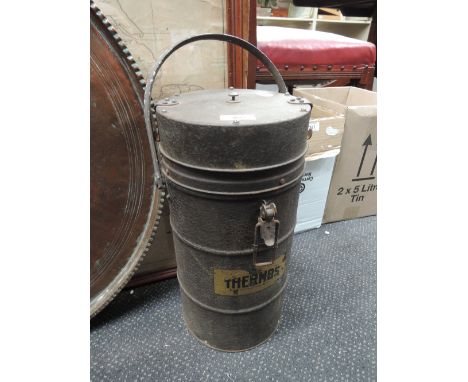 A vintage Thermos canister, containing jerry cans