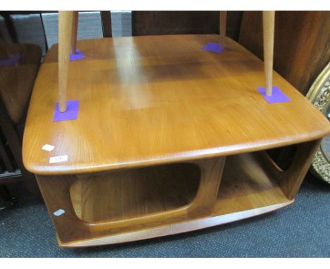 An Ercol style centre coffee table having library rack inspired shelf