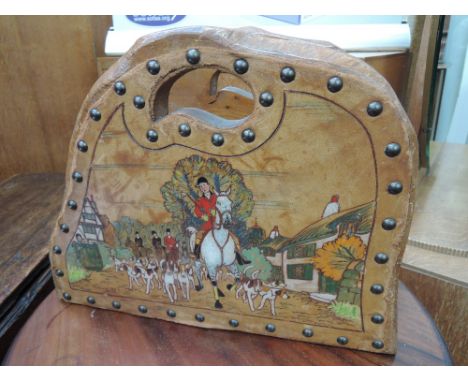 A vintage rustic treen magazine rack/stand having studded leather pictorial decoration of hunting interest 'moving off'
