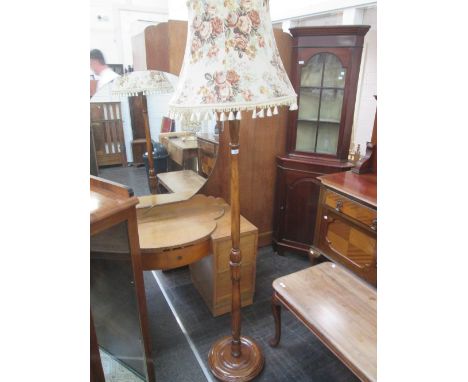 A mid 20th century beech standard lamp with floral fringe shade