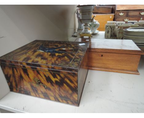 A vintage tin box having tortoiseshell effect and golden oak casket