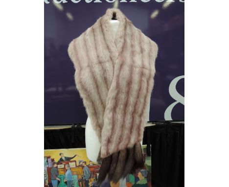 A vintage fox fur stole with iconic pink stripes and fox tail tendrils to the edges, lined in mauve satin.