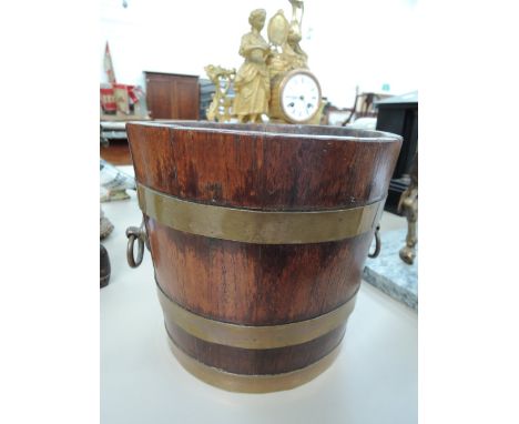 A vintage oak brass bound barrel planter, stamped Champion & Co