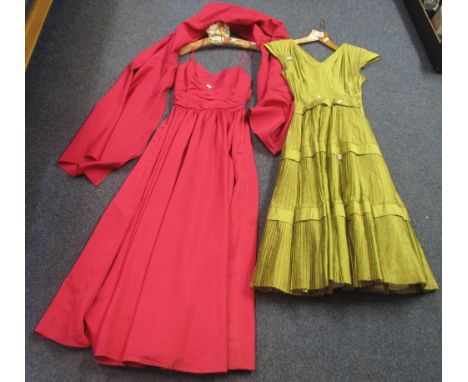 Two vintage 50's/60's dresses to include; a green cap sleeve dress with pleated tiered skirt and a fuschia ball dress with ma