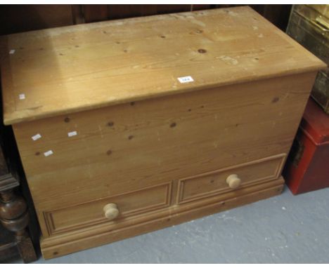 Pine trunk with two fitted drawers on a platform base. (B.P. 24% incl. VAT)