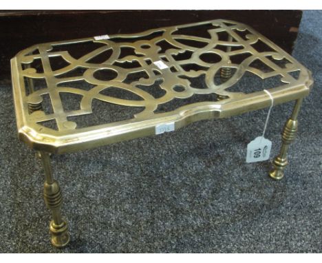 Arts and crafts design pierced rectangular trivet stand on ring turned legs. (B.P. 24% incl. VAT)