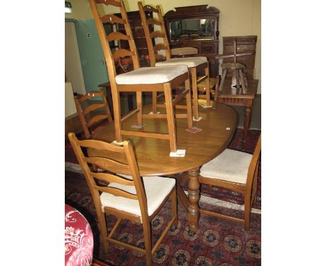 Ercol elm extending oval dining table on X stretcher support, together with a set of six ladder back dining chairs all with g