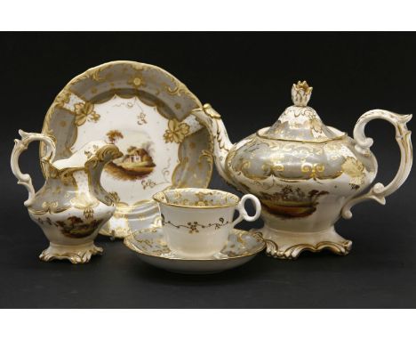 A 19th century Rockingham tea service, the landscape decorated centre within a green gilt border