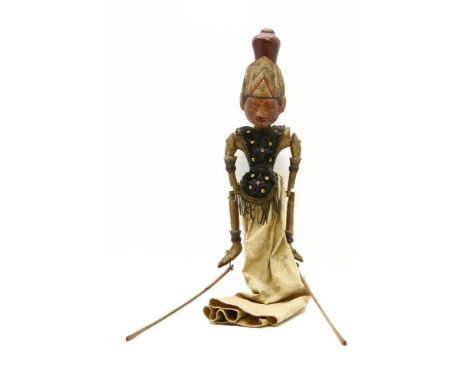 A hand carved and painted Nepalese wooden puppet, dressed in traditional costume, 70 cm high