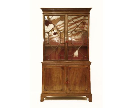 A George III design mahogany bookcase, with a pair of bar glazed doors above cupboards, on bracket feet, 118 x 48 x 216cm