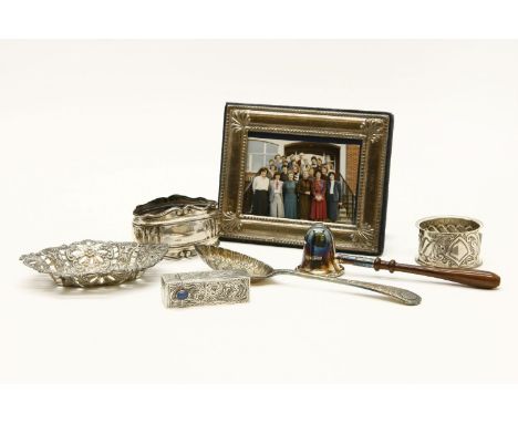 A small collection of silver items, comprising two napkin rings, a toddy ladle, a small photograph frame and a pin tray, toge
