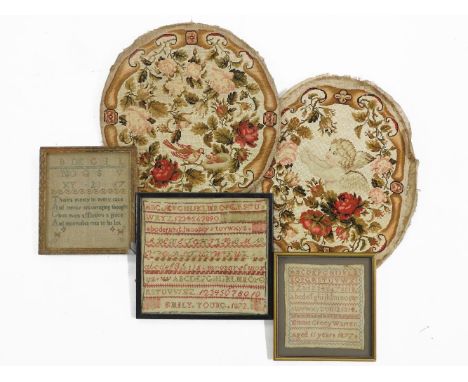 Three Victorian samplers, with alphabet and pictorial detail, together with two tapestry panels depicting a cherub amongst fl