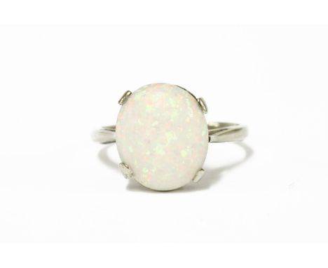 A white gold single stone opal ring cabochon ring, four claw set to a plain polished shank, marked 925, size M2.46g