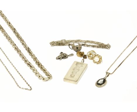 A collection of jewellery to include a single row coral twig necklace, a sterling silver Jubilee ingot, a silver three gate l