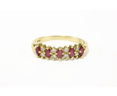 An 18ct gold five stone marquise cut ruby ring, with four pairs of diamond set points2.74g size P 1/2