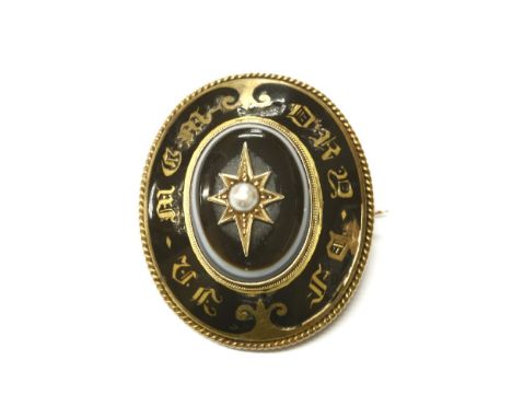 A gold memorial brooch, seed pearl star set to a banded agate cabochon to a black enamel border, with gold lettering to read 
