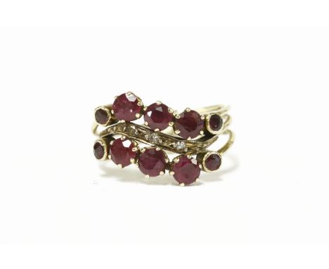 A gold three row wave head ruby and diamond band ring, hinged at base3.82g size L approx