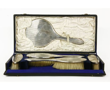 A silver backed brush set,  with engine turning, hallmarked for Birmingham 1923