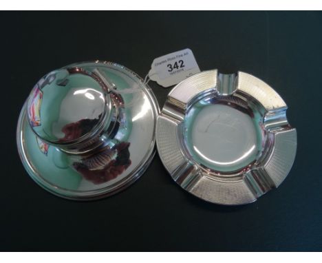 A circular silver Capstan inkwell, together with a silver ashtray, various dates and makers.
